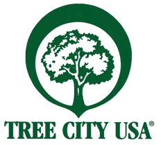 A logo with a tree and circle for Tree City USA